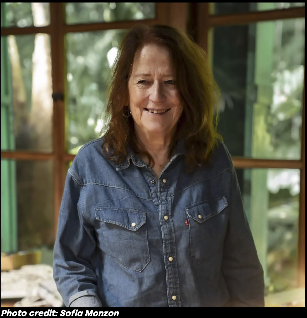 A photo of the artist Vivian Suter, a mature woman with brown shoulder length hair.