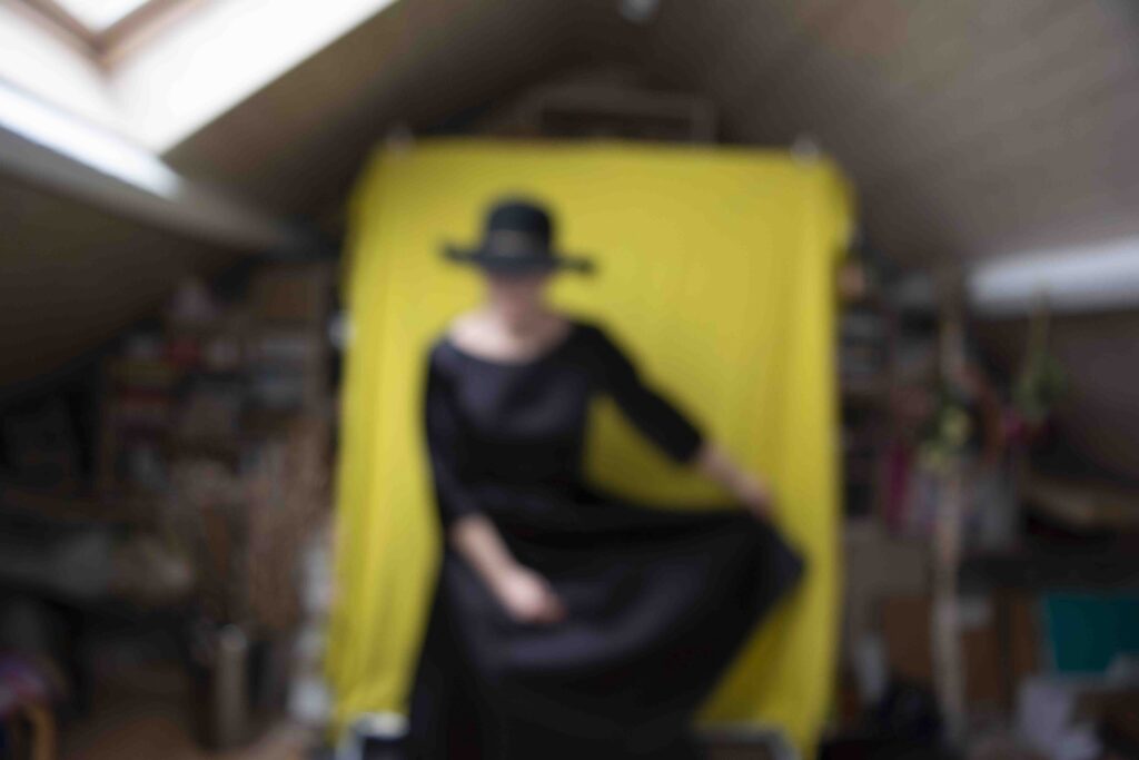 Photo shoot of a black dress in a small loft space under the eaves.